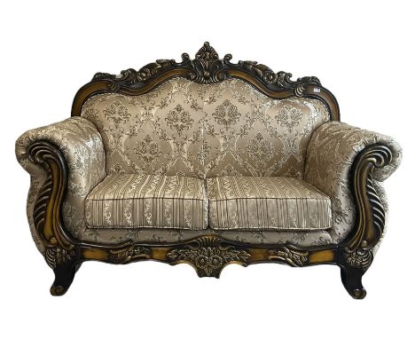 Italian Baroque design two seat sofa, hardwood framed, the cresting rail carved and pierced with c-scrolls and flower heads, 