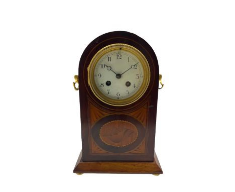 A decorative early 20th century French mantle clock in a round topped mahogany case with inlaid satinwood stringing and a con