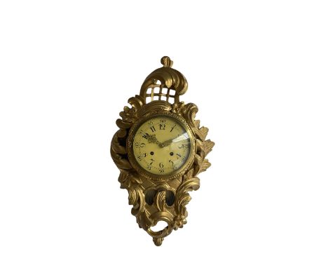 A mid 20th century wooden gilt painted cartel clock in the French 18th century Rococo style, cream painted dial with Arabic n