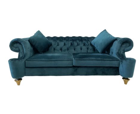 Chesterfield style two seat sofa, scrolled arms and uprights, upholstered in buttoned teal velvet, on turned tapering brass f