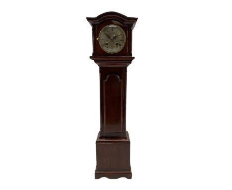 A late 19th century miniature replica of a mahogany longcase clock with a removable break arch hood, opening hood door with a