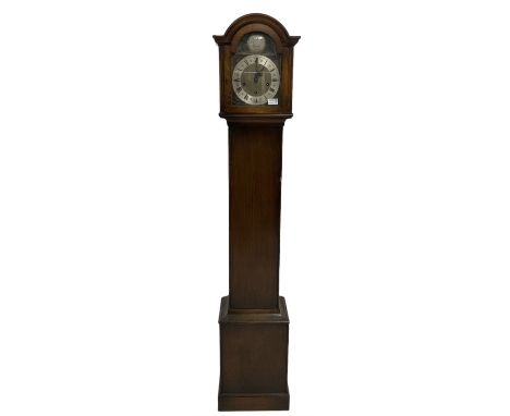 Plain dark oak cased “Grandmother” clock with a break arch top and conforming glazed hood door, with a stylised 18th century 