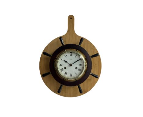 Late 20th century German “Schatz” ships bulkhead clock in a brass case with a ships wheel surround, eight-day spring driven m