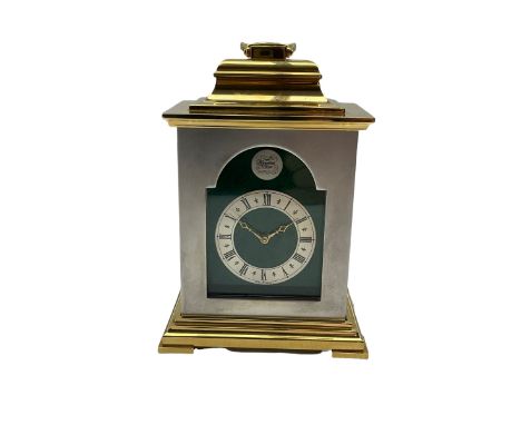 Thwaites and Reed twentieth century carriage clock in a brass and steel finished case with an inverted bell top and carrying 