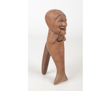An early 20th century Continental carved wood nut cracker formed as an old woman, 21.25cm.  Good condition. Good action.