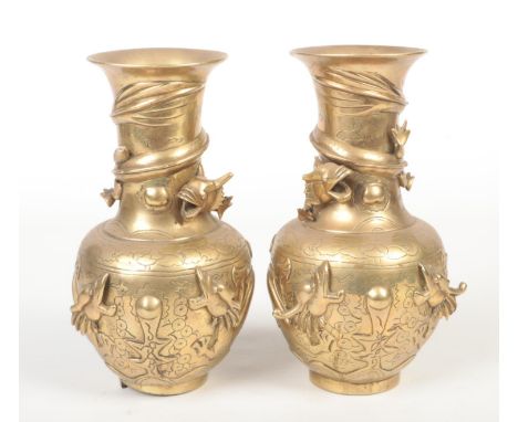 A pair of early 20th century Chinese polished bronze vases decorated with coiled dragons. Seal marks, 24.5cm.  