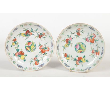 A pair of Chinese dishes decorated in polychrome enamels with peaches, pomegranates and pineapples. Red printed Daoguang seal