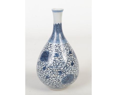 A Chinese small pear form bottle vase. Painted in underglaze blue in heaped and piled style with a collar of stiff leaves and