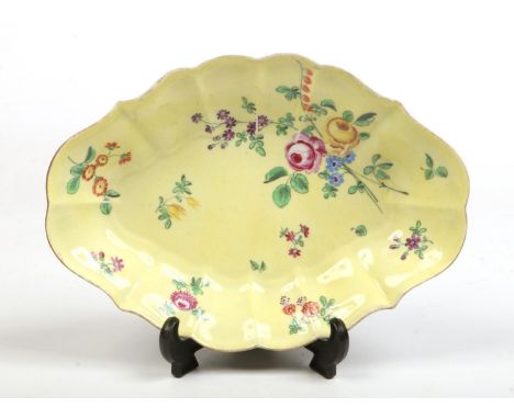 A Worcester scalloped lozenge shaped dish. Yellow ground, with gilt rim, enamelled with a bouquet and scattered sprigs c.1760
