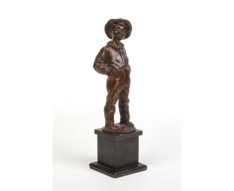 A bronze figure of a young boy raised on a square slate plinth. Modelled smoking a cigar, stood with his hands in his pockets