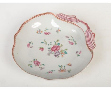 An 18th century Chinese export shell formed dessert dish. Painted in the famille style with flowers under a red enamel and gi
