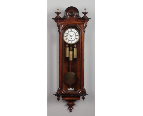 A 19th century walnut cased Vienna wall clock by Gustav Becker. With ebonized mouldings and enamel dial. Housing an 8 day 3 t