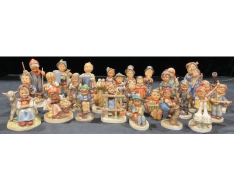 A collection of Goebel Hummel figures including Hear Ye, Hear Ye; For Father; Boots; Street Singer; Happy Days; Good Friends;