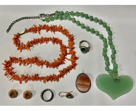A Chinese jade pendant necklace; a coral necklace; an eternity ring; etc 