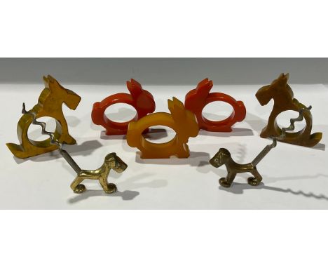 An Art Deco Bakelite animal napkin rings and corkscrews 