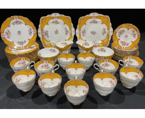 A Paragon tea set, comprising pair of sandwich plates, twelve cups, saucers and tea plates, two set of milk jugs and sugar bo