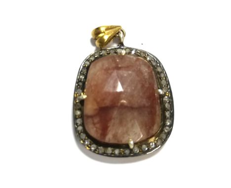 An unusual ruby and diamond pendant