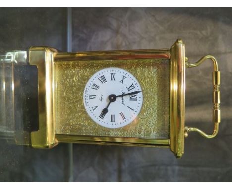 A brass carriage timepiece, retailed by Boyard, with scroll chased and enamel dial, the movement by Duverdrey &amp; Bloquel 1