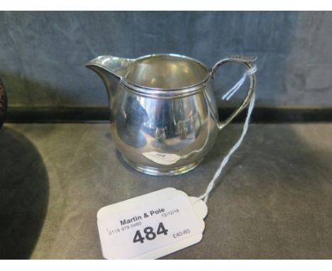 A small silver cream jug together with a matching two handled sugar basin, mixed dates
