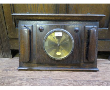 An oak hallrobe, with lunette carved panelled door, 96cm wide 176cm high and an oak hall unit with barometer and two clothes 