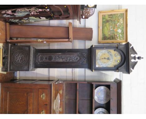 A late Victorian carved ebonised longcase clock, the arched engraved dial with silvered chapter, subsidiary seconds, strike/s