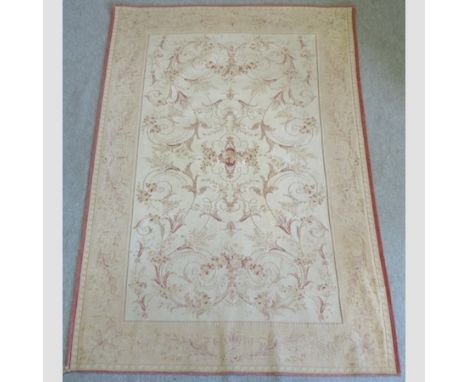 A modern tapestry style rug, with floral designs, on a cream ground, 237 x 167cm