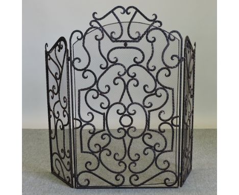An iron open work three fold fire screen, 104cm tall