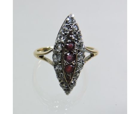 An early 20th century 18 carat gold ruby and diamond cluster ring, of elliptical shape, boxed