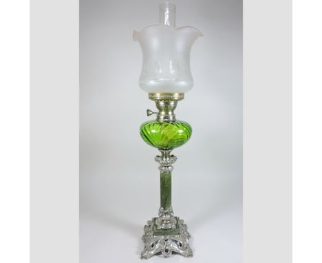 A green glass and plated oil lamp, with an etched glass shade, 65cm tall