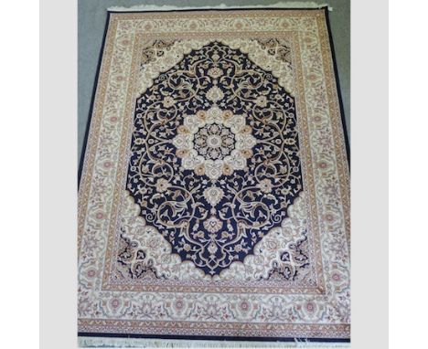 A Keshan carpet, with a central medallion, on a blue ground, 280 x 200cm