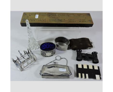 A collection of silver to include a toast rack, purse, engraved bangle and a salt, together with a scent bottle, cribbage and