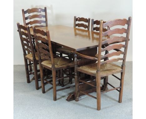 An oak refectory table, 158 x 81cm, on a trestle base, together with a set of six ladder back dining chairs, to include two c