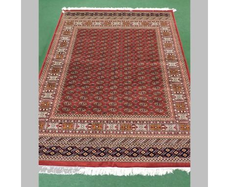 A Bokhara carpet, on a red ground, 280 x 200cm