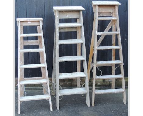 A wooden step ladder, 154cm tall, together with two others 
