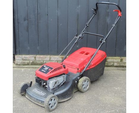 A black Mountfield petrol rotary lawn mower, with manual 