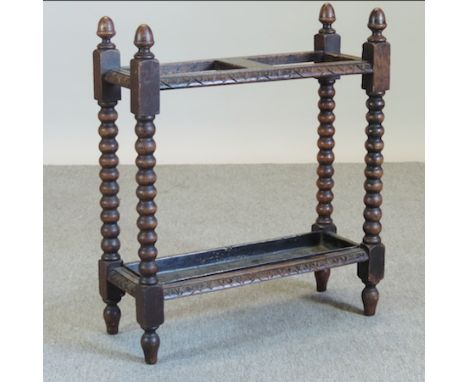 A 1920's carved oak stick stand, 60cm