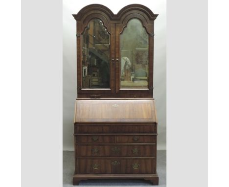 A George I style walnut and cross banded double dome bureau cabinet, on bracket feet, 99cm