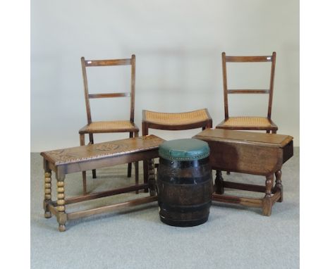 A pair of cane seated chairs, together with a matching stool, an oak drop leaf table, a wine table, and a carved bench and ba