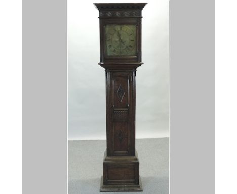 An early 20th century carved oak cased longcase clock, with an engraved brass dial, signed Maple, London, having Westminster 