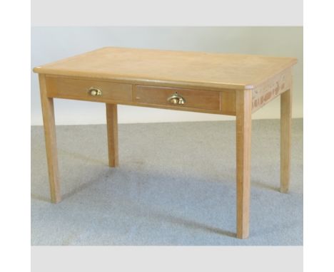 A contemporary light oak writing table, containing two drawers, 128cm