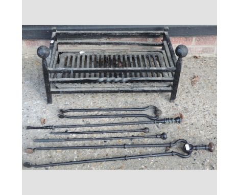 A cast iron fire grate, together with fire tools