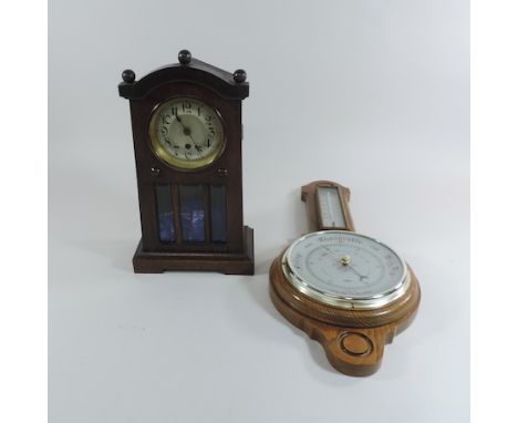 An early 20th century oak cased mantle clock, 33cm tall, together with an aneroid barometer