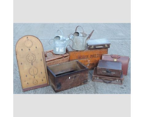 A collection of items to include wooden crates, suitcases, galvanised watering cans and a wicker hamper