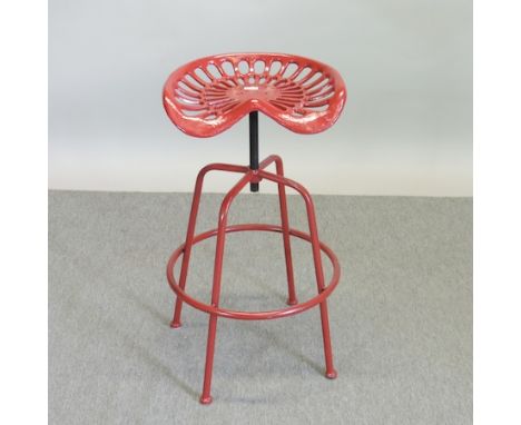 A red painted metal tractor seat stool, 46cm