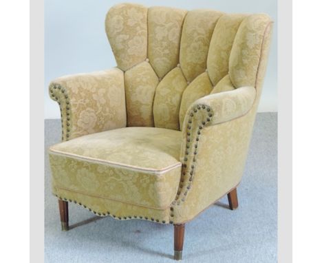 A 1940's French gold upholstered and studded button back arm chair, on reeded legs 