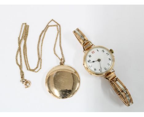 Lady's vintage 9ct gold cased wristwatch on 9ct bracelet strap and a yellow metal locket on a 9ct gold trace link chain (2) 