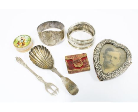 Victorian silver caddy spoon, Newcastle 1850, two silver napkin rings, pickle fork, small photograph frame, miniature book 'S