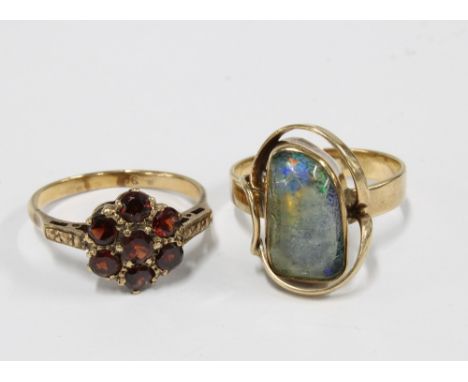 9ct gold opal dress ring and a 9ct gold garnet flowerhead ring (2) 