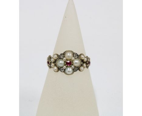 19th century ruby, pearl and diamond mourning ring with a flowerhead setting of four pearls and four diamonds with a ruby cen