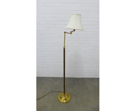 Adjustable brass standard lamp with rise and fall action, complete with shade. 160cm high. 